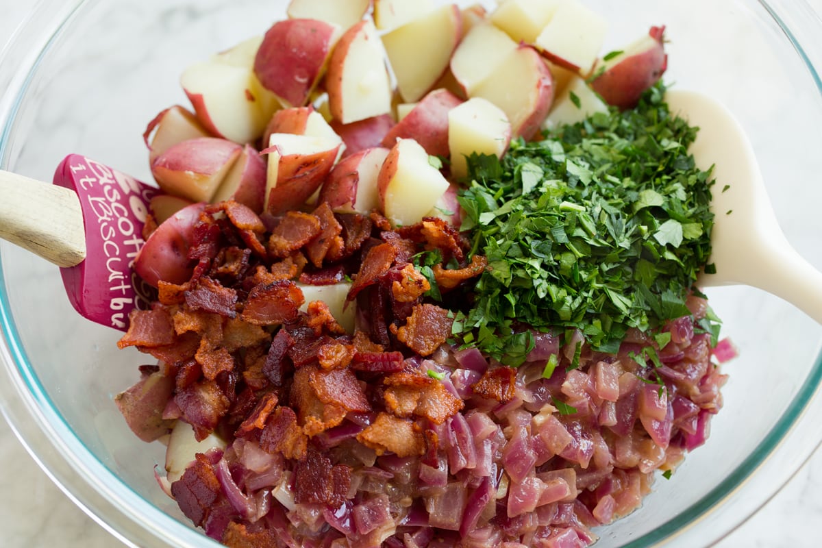 Prepared German potato salad ingredients shown in a mixing bowl before tossing.