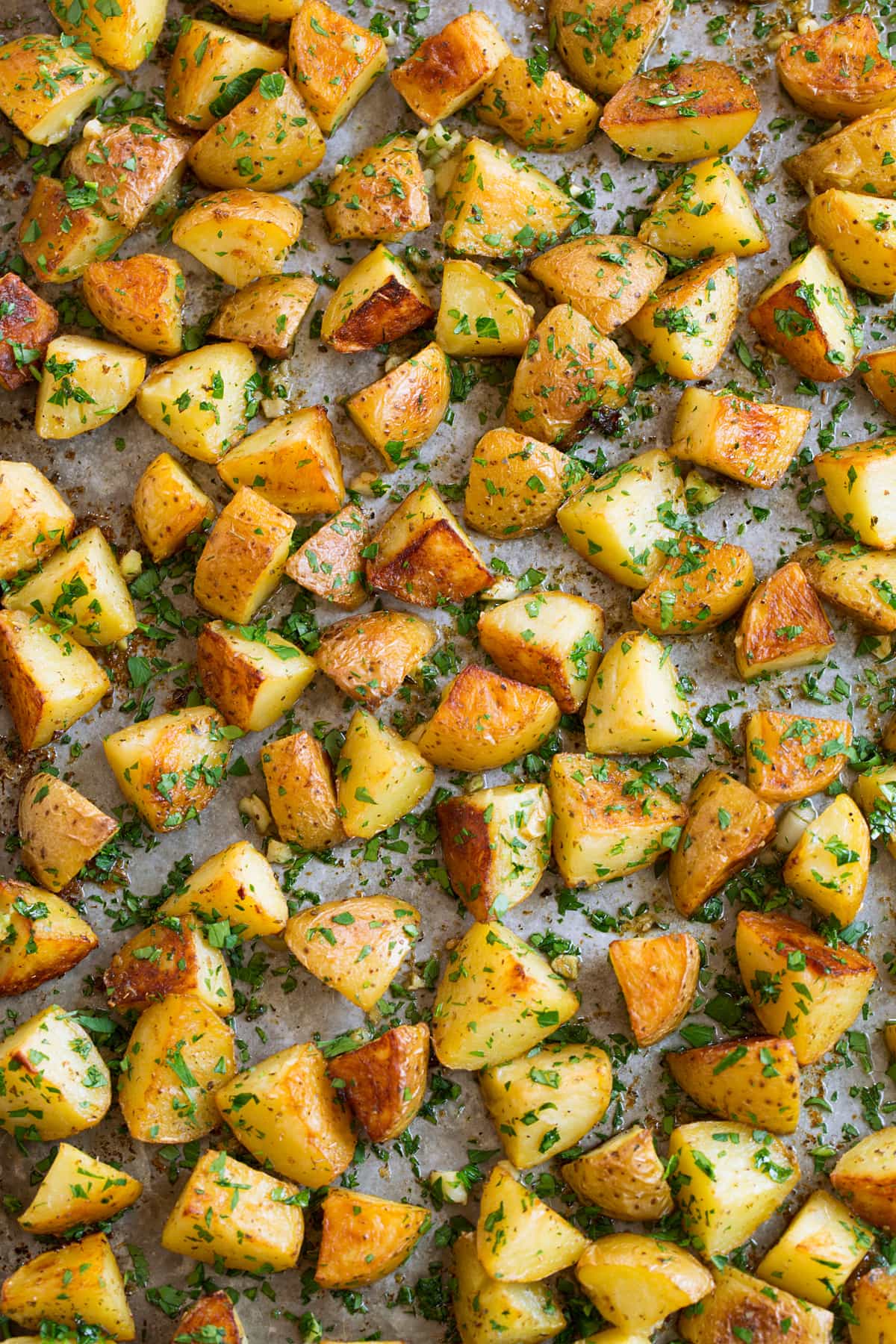Patate Al Forno Al Limone Overhead image of lemon potatoes on a metal sheet pan.