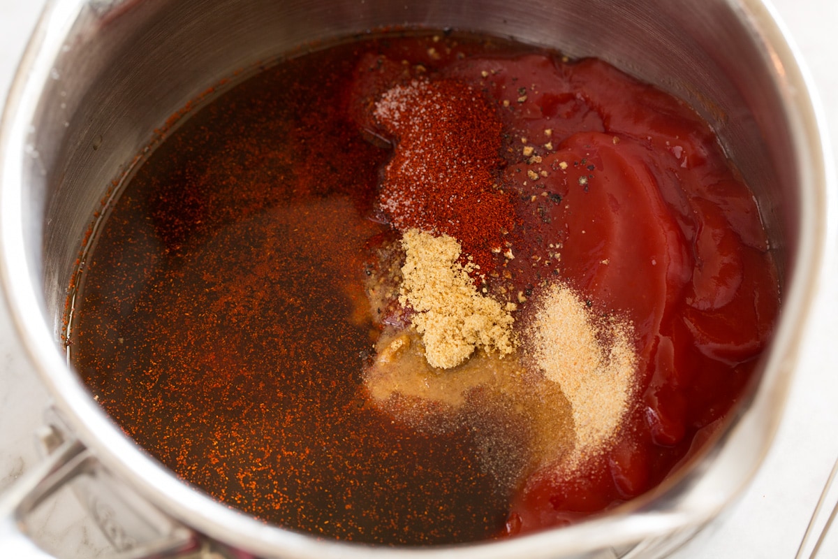 Salsa barbecue fatta in casa BBQ sauce ingredients in a saucepan before mixing.