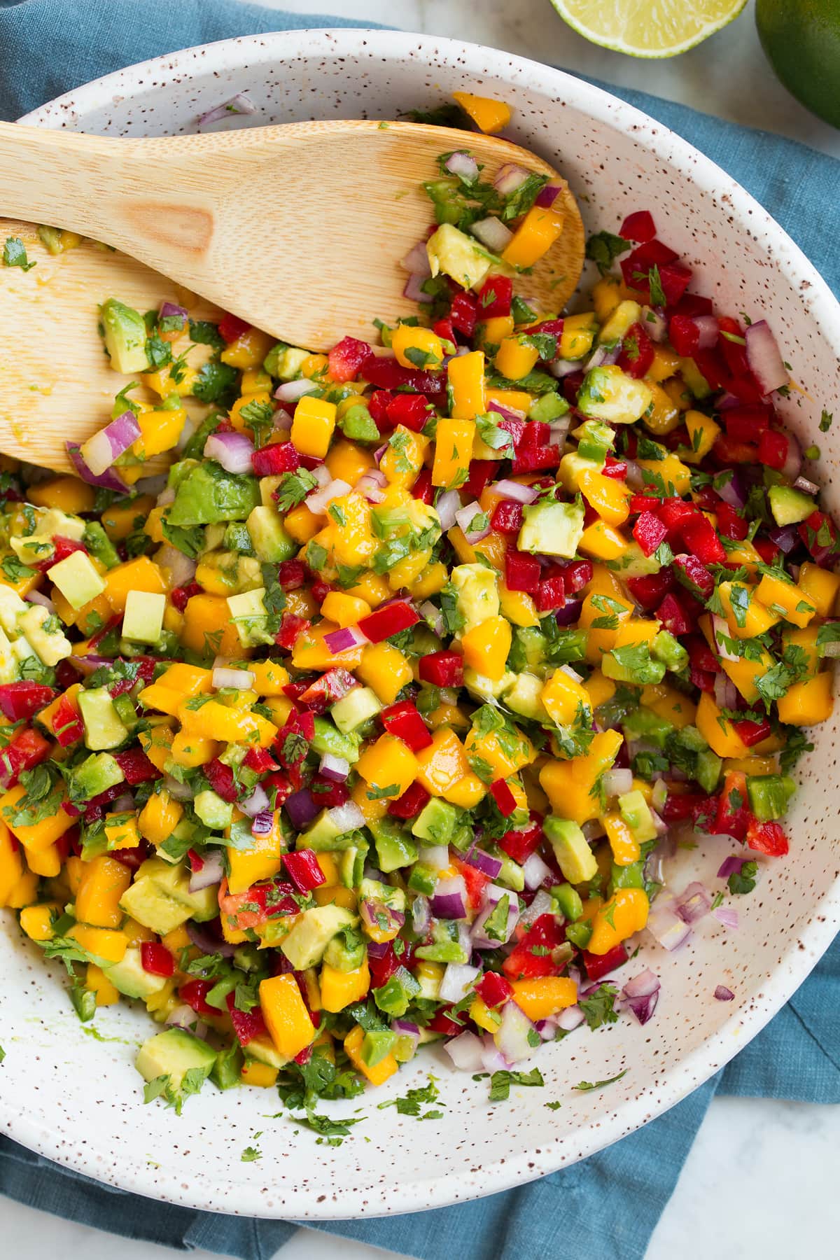Salsa di mango (con avocado!) Close up image of mango salsa shown after tossing ingredients.