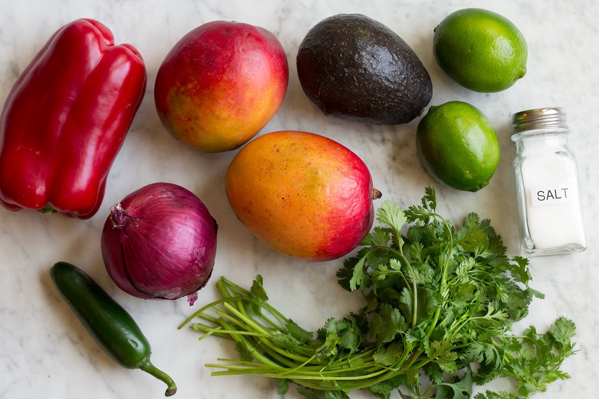 Salsa di mango (con avocado!) Image of ingredients used in mango salsa. Includes fresh mangoes, avocado, bell pepper, cilantro, red onion, lime, jalapeno and salt.