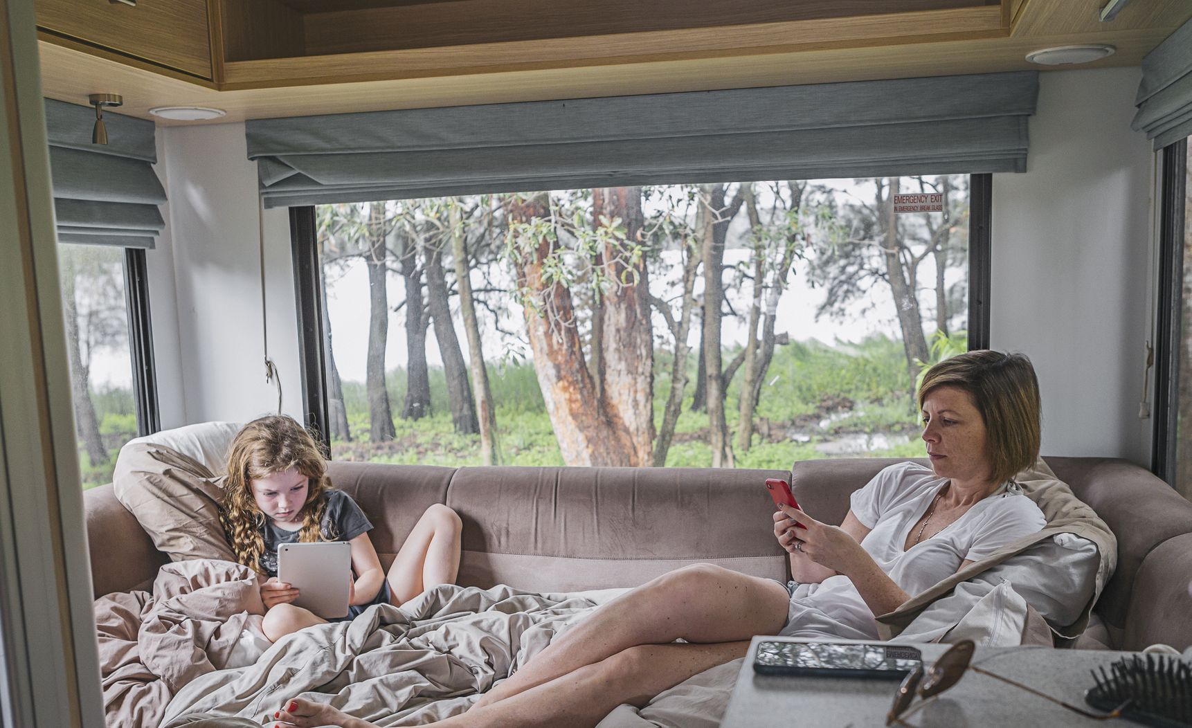 mother and daughter using tech inside motor home