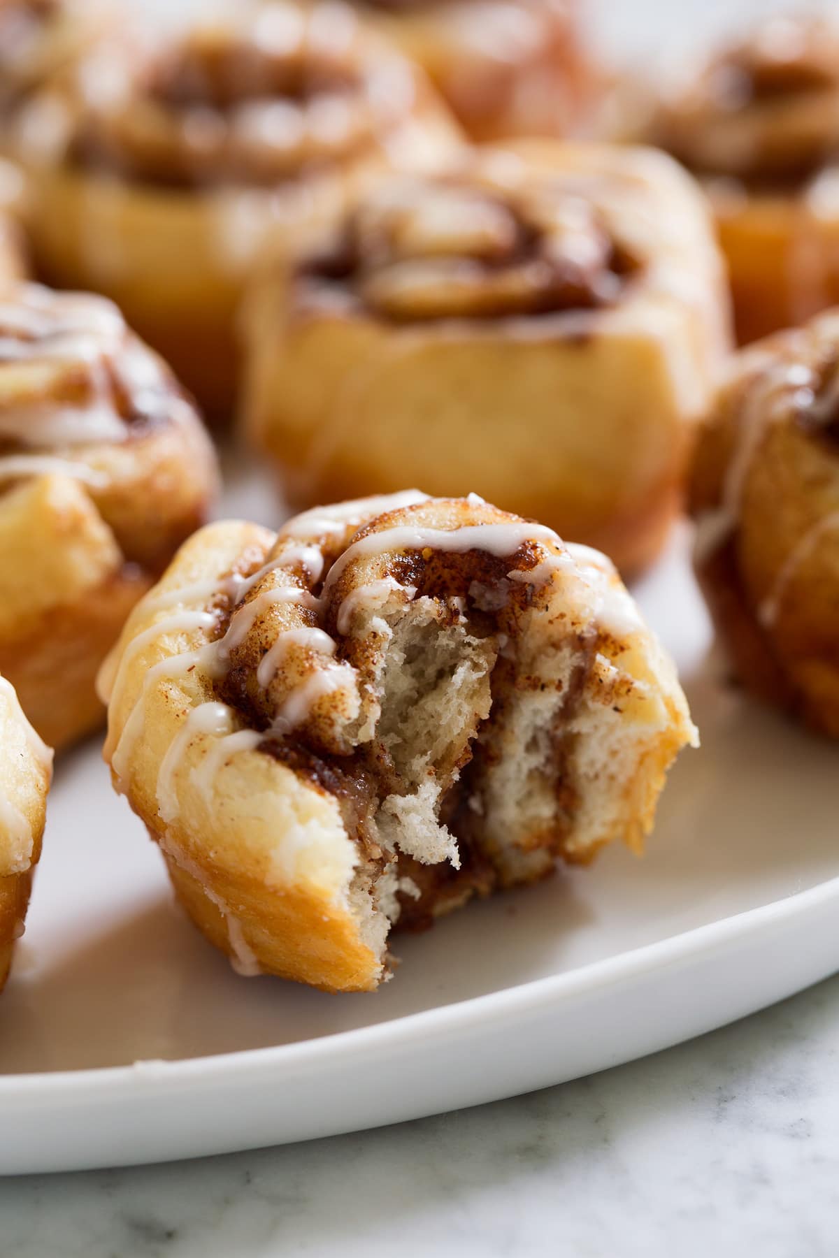 Mini Panino Alla Cannella Image of mini cinnamon roll shown bitten into.