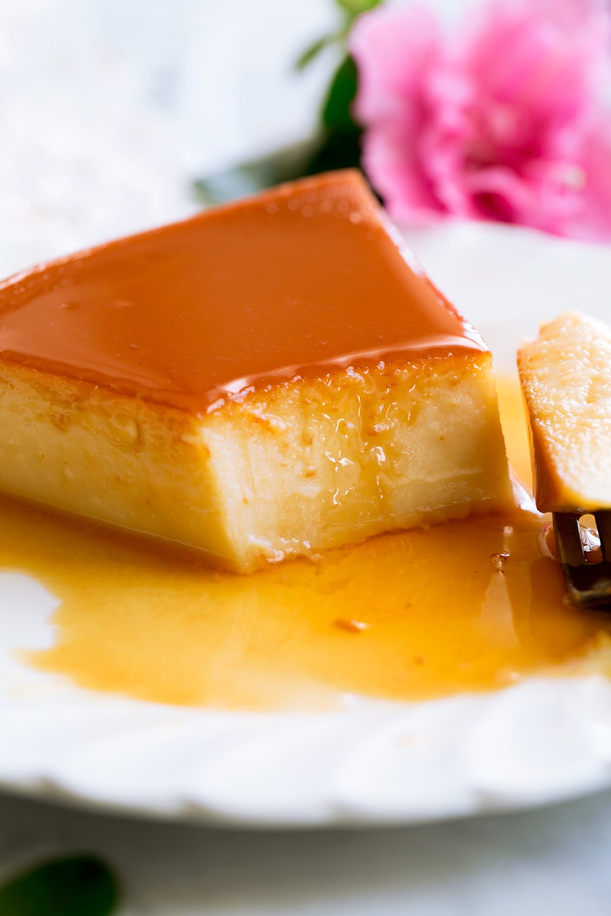 Ricetta Flan Close up image of flan cut into with a fork.